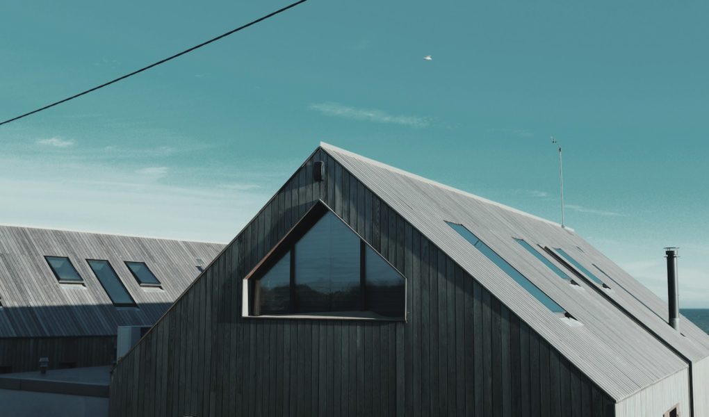 gray wooden house near body of water