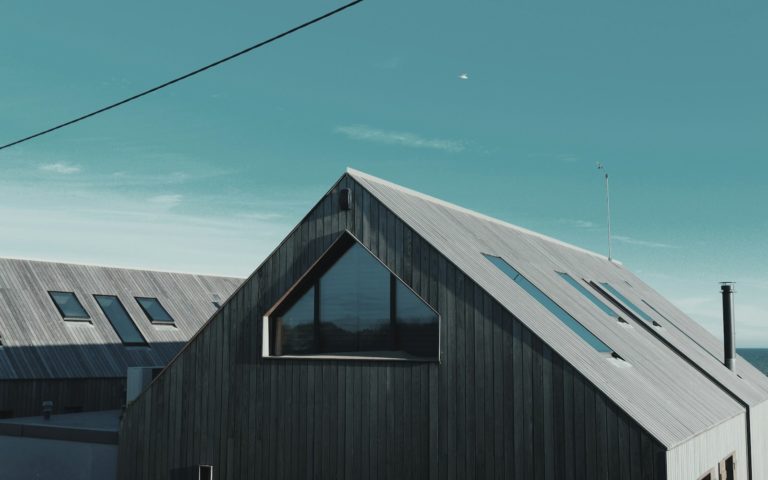 gray wooden house near body of water
