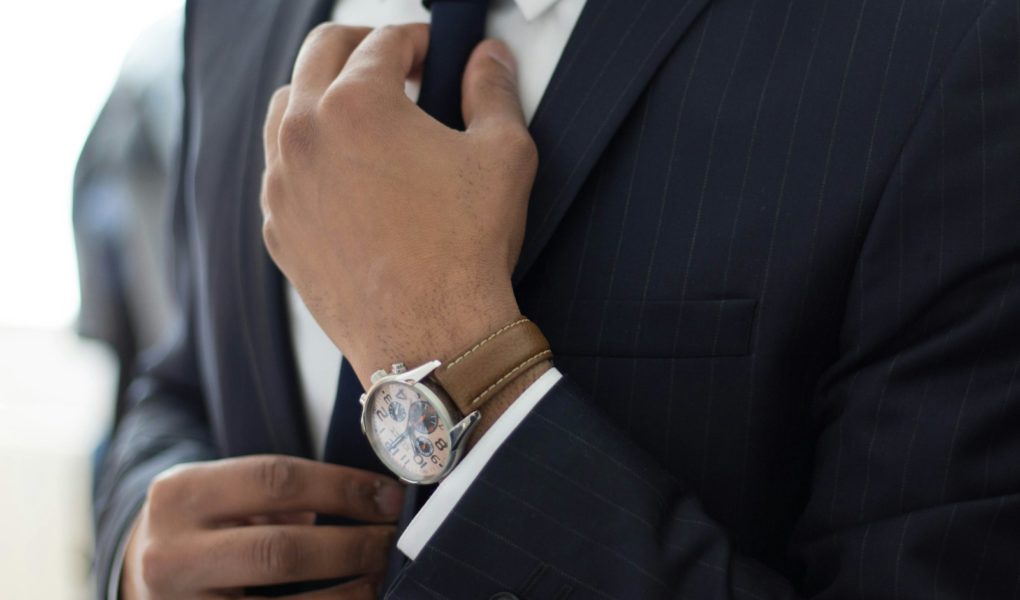 man wearing watch with black suit