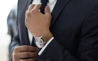 man wearing watch with black suit