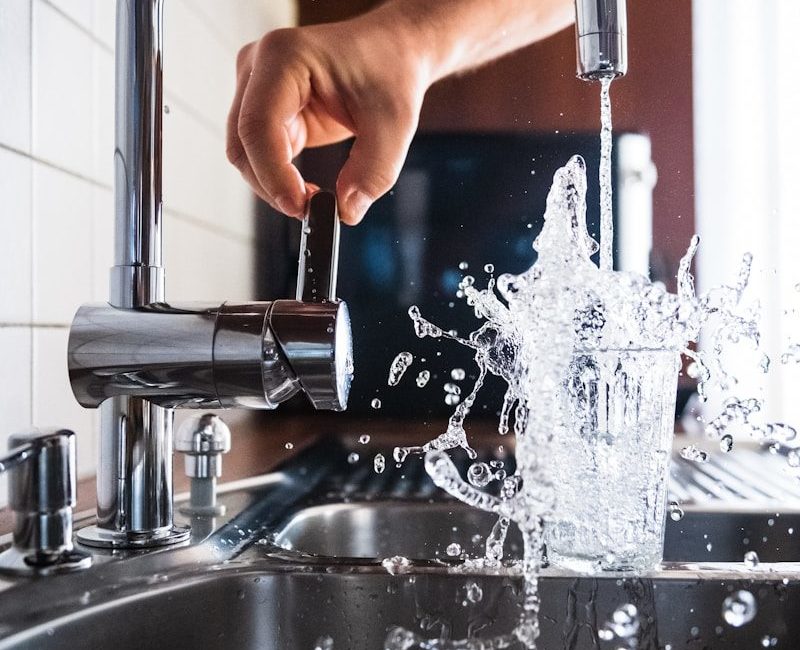 person opening faucet